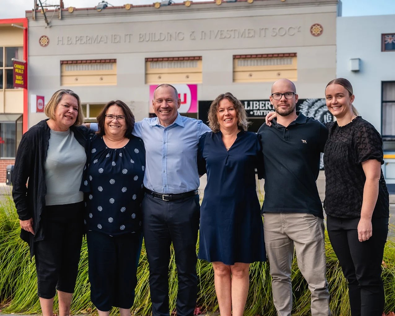 The YOU Travel Napier team outside their art deco office on Tennyson Street, Napier